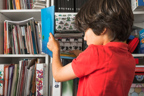 kid-taking-book-from-shelf